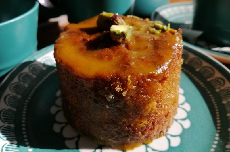 Carrot Cake A small round carrot cake smothered in a light caramel glaze with a pistachio on top