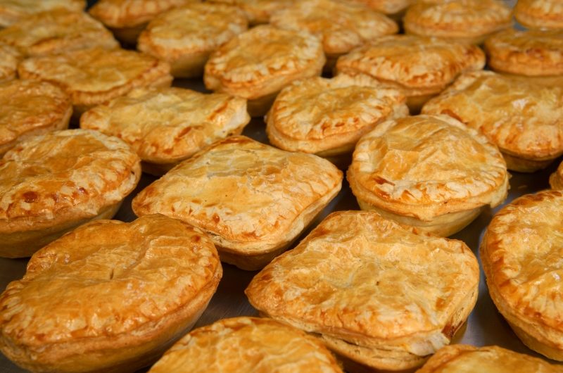 Rows of oval Gourmet pies and square Vege pies fresh out of the oven