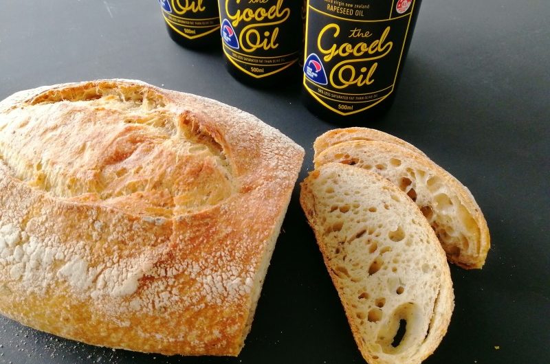 September Horopito Sourdough and The Good Oil A loaf of Horopito Sourdough with two slices and bottles of The Good Oil in the background